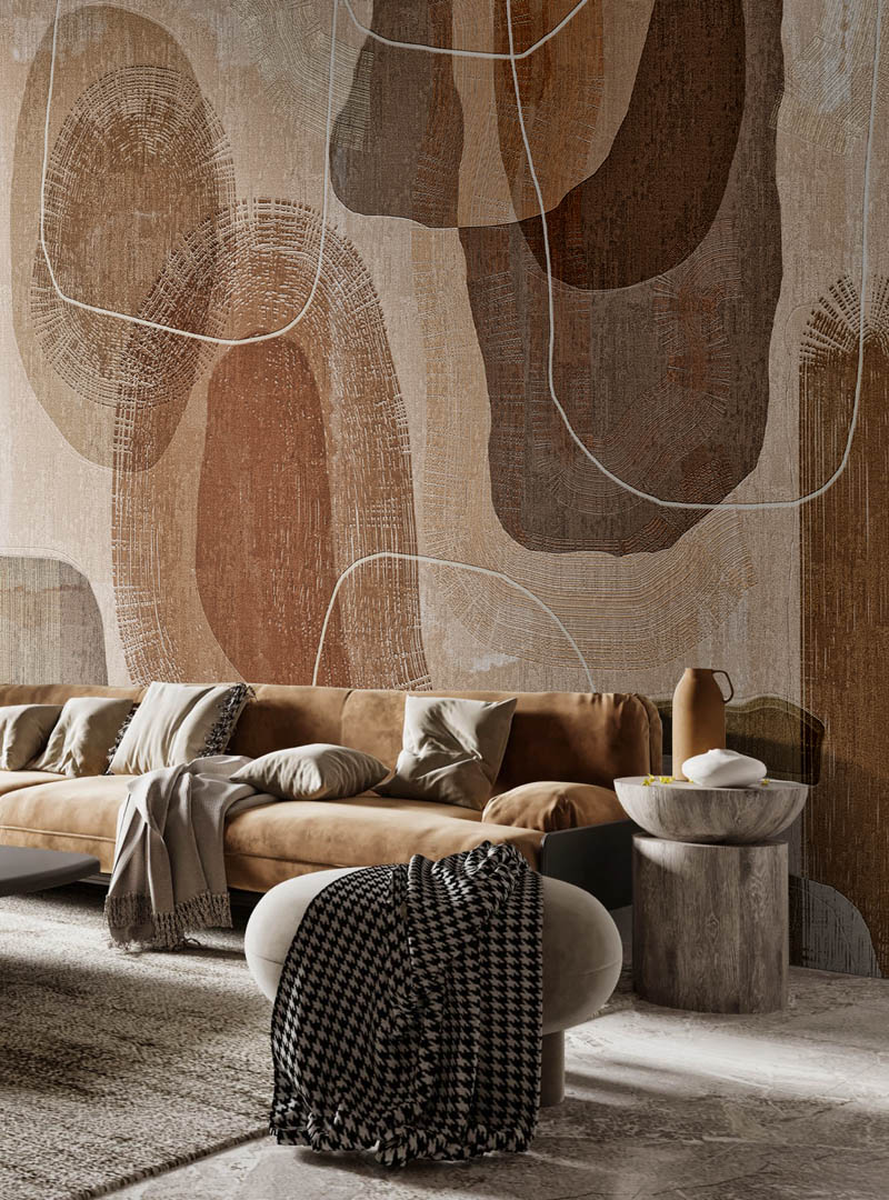 Toronto wallpaper installation featuring the Primordial Forms mural in a warm, modern living room with suede seating and layered neutral textures.