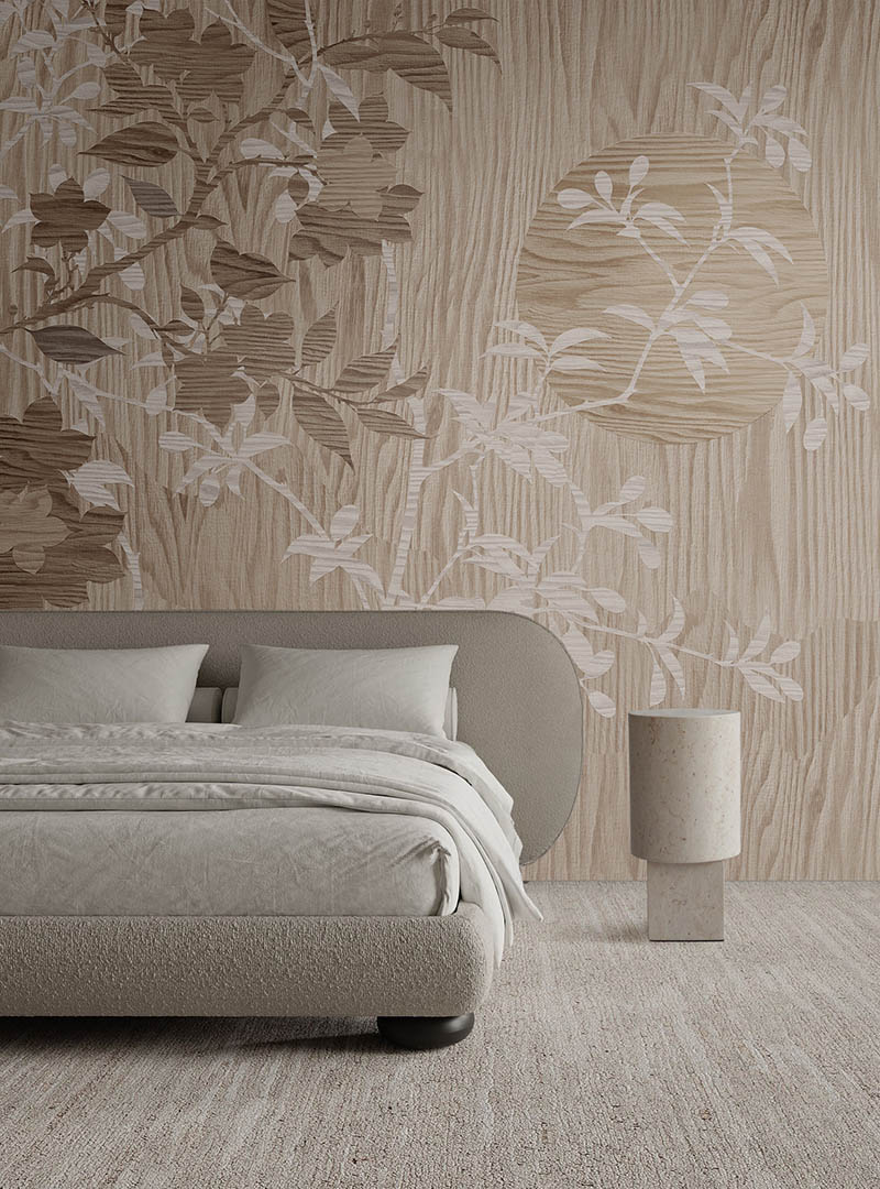 Haru III botanical wallpaper installed behind a neutral upholstered bed in a warm contemporary bedroom.